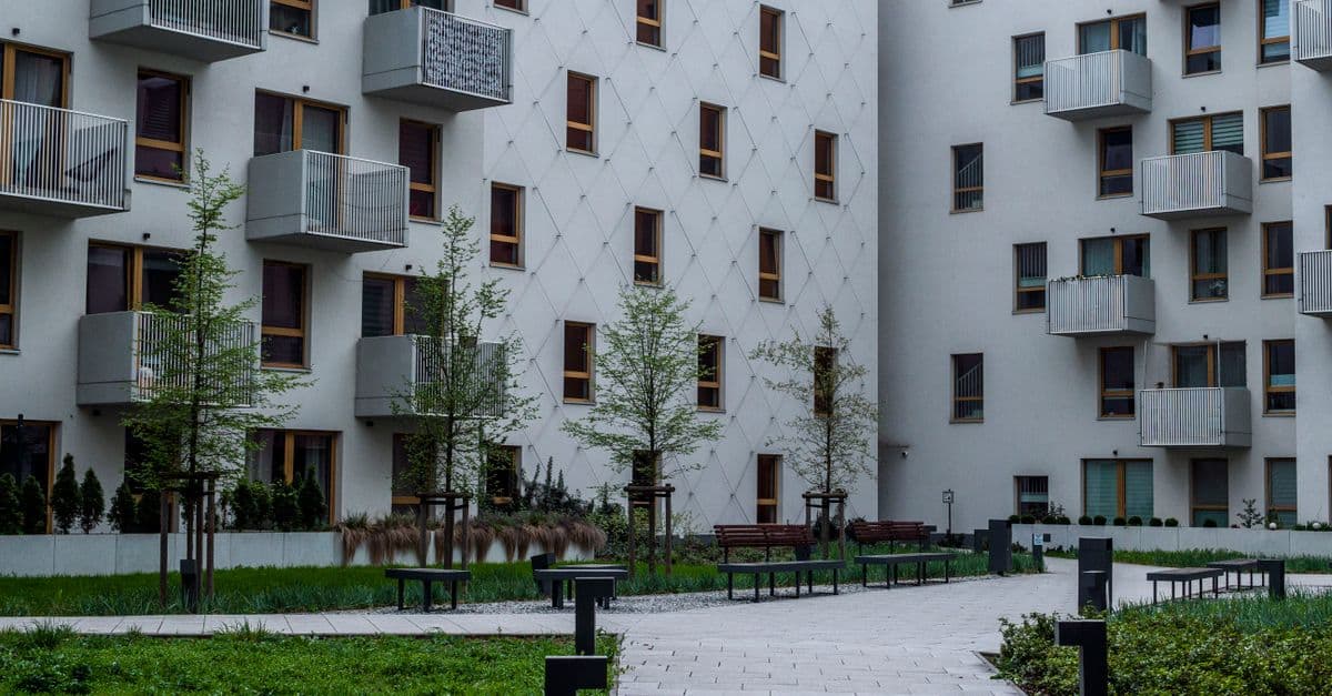 A contemporary apartment complex with a landscaped courtyard and balconies, the kind of property that carries several funding programs at once.